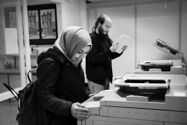 A man and a woman use printers. Photographer Johan Bävman.